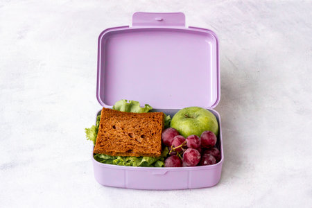 Sandwich and fruits in lunch box. Healthy snack meal
