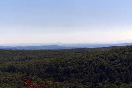 Wide view from mountaintop of hazy skyの写真素材
