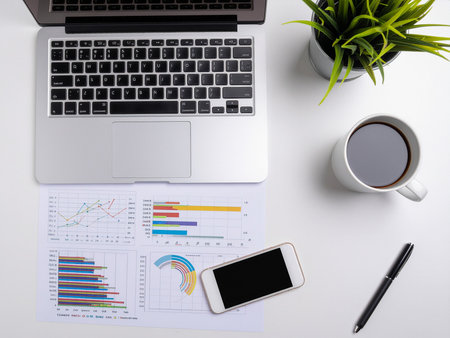 Office desk table with laptop, smartphone and coffee cup. Top viewの素材