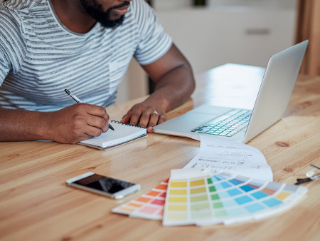 Cropped image of male designer working with color swatches in officeの素材