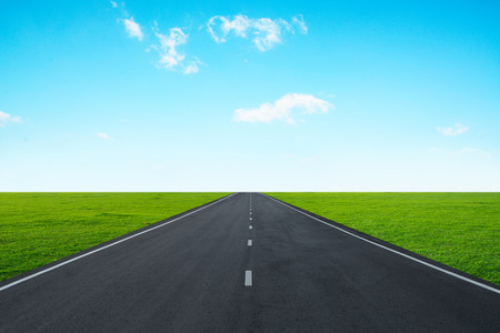 Asphalt road with blue skyの写真素材