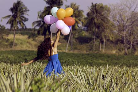 The girl flying with balloons. Vintage styleの写真素材