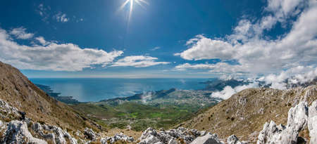 Sunny day. Blue sky with clouds and beautiful view from the mountains to the sea and to the Bar...