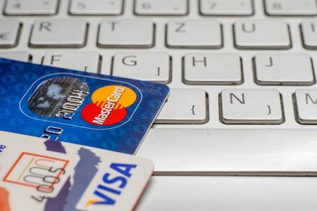Sarajevo, Bosnia and Herzegovina - January 25 , 2017: closeup pile of credit cards, Visa payWawe and MasterCard, credit, debit. On laptop keyboard.のeditorial素材