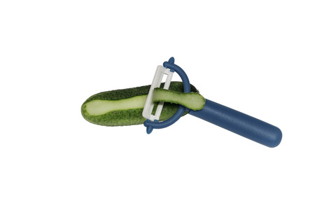 Ceramic Vegetable Peeler with blue handle and cucumber isolated on white background. With clipping path. Design element.の写真素材