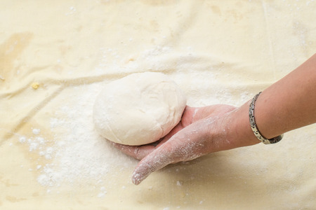 Female hand hold dough for pie