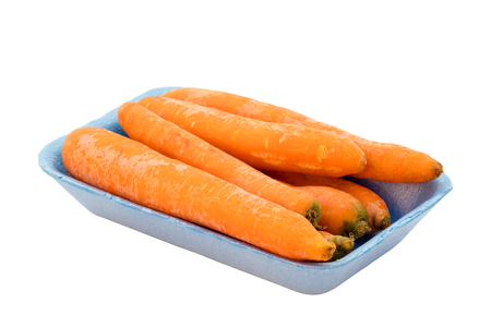 Carrots in blue retail package, isolated on white background with clipping path.の写真素材