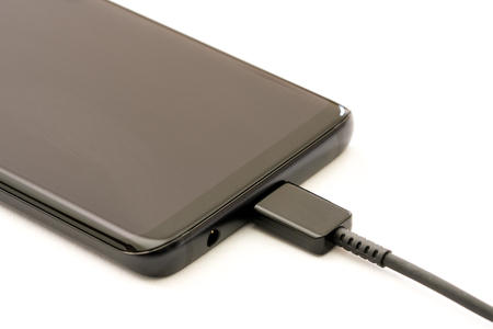 Smartphone charging. Isolated on white background.の写真素材