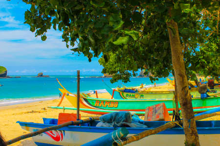 Beautiful views of Indonesia's tropical beaches, many fishing boats are pulling over and taking shelter under the treesの写真素材