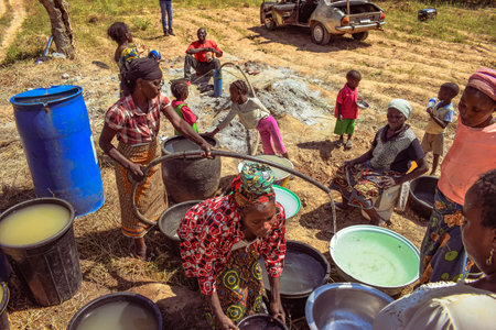 African Women fetching raw untreated water for household consumptionのeditorial素材