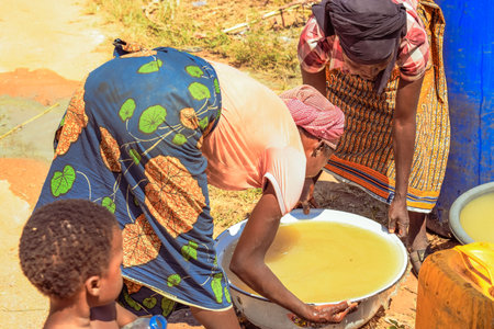 African Women fetching unclean water for household consumptionのeditorial素材