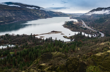 A wide view of the the Columbia River in Oregon, USA on an overcast day, the river stretching out into the distanceの写真素材