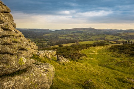 A panoramic view of Dartmoor National Park from Watern Tor, the green landscape leads into the distance, an overcast skyの写真素材