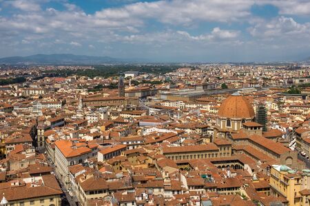Florence, Italy, July, 28, 2017: A sweeping view of the skyline and rooftops of Florence from the top of Giottos bell tower, next to the cathedral, looking out towards the main railway station, against a clear blue sky.のeditorial素材