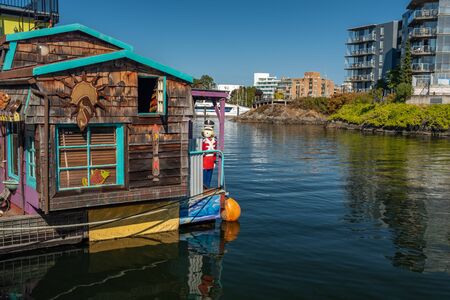 Victoria, Vancouver Island, British Columbia, Canada, July, 8, 2018: The floating homes in Victoria against a backdrop of modern apartment block, nobody in the imageのeditorial素材