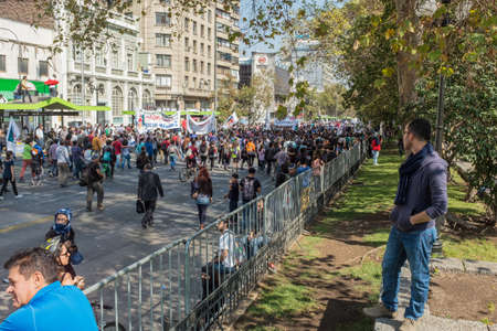 Student protest in Santiago, Chile, March, 17, 2015: A view from the crash barrier, students take to the streets in Santiago, Chile to protest against the cost of education.のeditorial素材