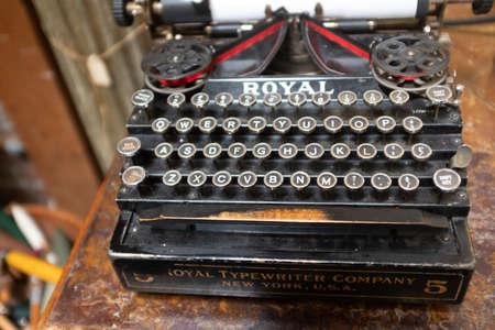 A close up of a vintage Royal typewriter showing signs of age on a wooden deskのeditorial素材