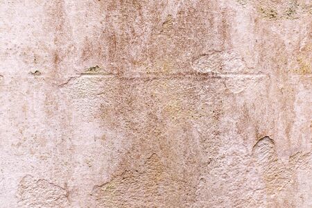 A close up photo of an exterior textured wall dirty pink color, surface with stucco daub, great for background imagesの写真素材