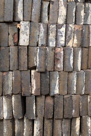 A close up of a pile of gray bricks ready for use, looking at the long edge of the bricksの写真素材