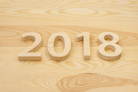 Wooden figures forming 2018, carved from light wood on the background of old wood. New Year Idea,...