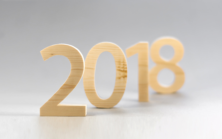 2018 Happy New Year, numbers cut from light  wood on a gray background. Soft focus.の写真素材