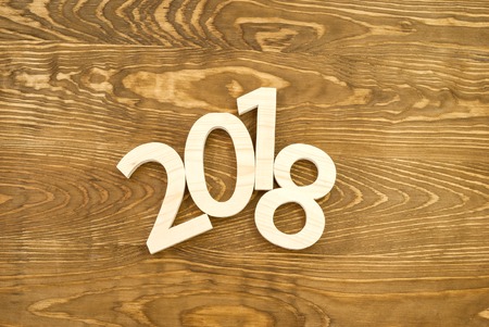 Wooden figures forming 2018, carved from light wood on the background of old wood. New Year Idea,...