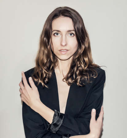 Nice girl in a striped t-shirt with vintage camera in her hands. Photographing people.の写真素材