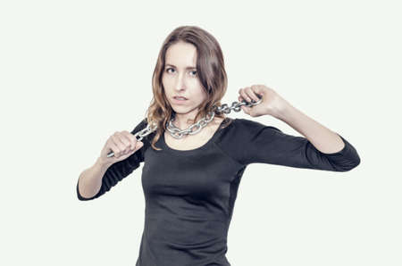 Nice girl in a striped t-shirt with vintage camera in her hands. Photographing people.の写真素材