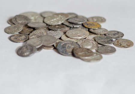 Antique Roman coins, small pile of cash on white backgroundの写真素材