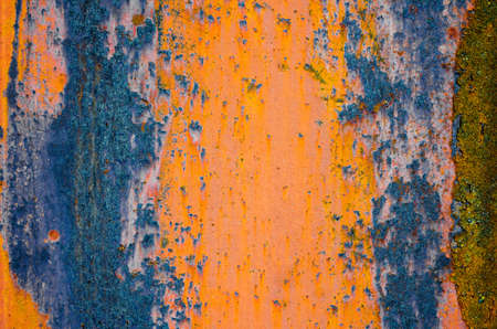Rusty metal surface, orange and blue color of iron oxide