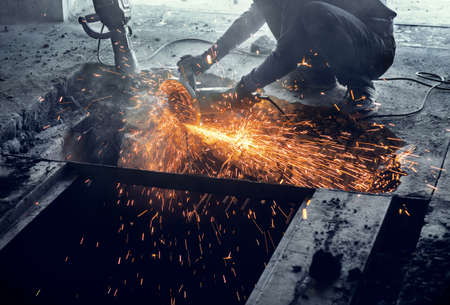 Cutting metal reinforcement in reinforced concrete. Sparks from friction with metal. Disassembly...