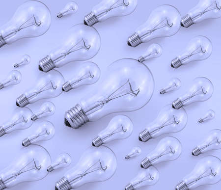 Set of several electric bulbs in one direction on a blue background.の写真素材