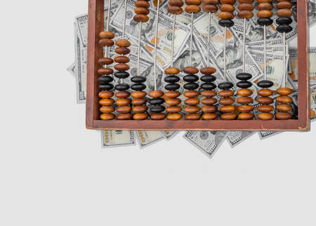 Old wooden abacus on a paper american dollars background. Bookkeeping, profit, business conceptの写真素材