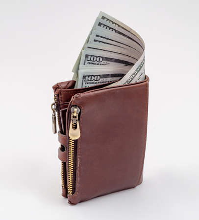 Brown wallet with money on a white background