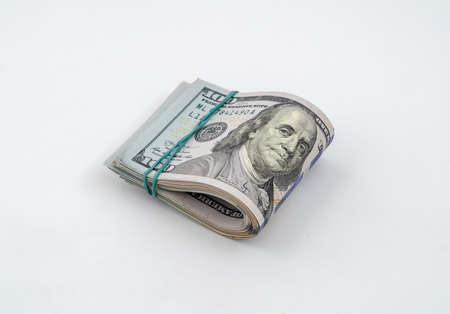 Stack of American dollars tied with a rubber band for moneyの写真素材