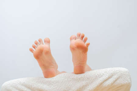 Slender female legs on the floor. One leg raised.の写真素材