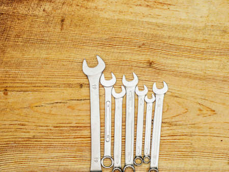 Spanners on a wooden board, top view
