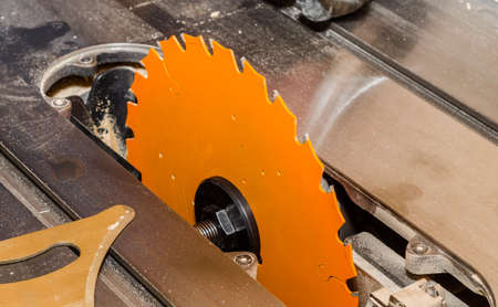 Orange circular saw in carpentry workshop