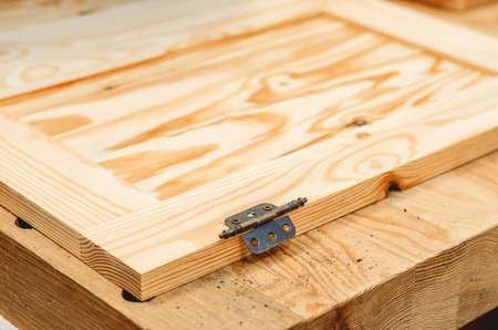 Door hinge is attached to the boardの写真素材