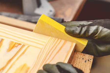 Manual sanding of wooden products. Hands of master