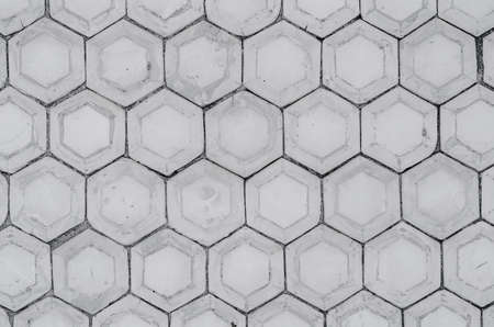 Concrete honeycombs on surface. Gray hexagonal tiles, honeycomb tiles texture background.の写真素材