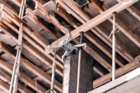 Modern gray drone on construction site. Blurred background. Modern technologies in the construction...