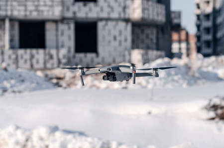 Modern gray drone on construction site. Blurred background. Modern technologies in the construction...