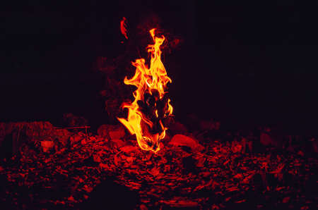 The glove is engulfed in flames. Bright fire in dark night.の写真素材