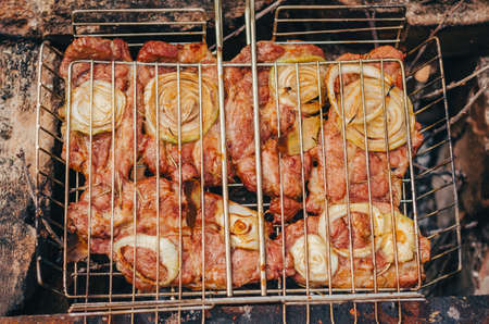 Top view on grill with meat. Cooking delicious food. Grilled meat with spices and vegetables.の写真素材