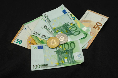 Woman holding euro cash in hand on black backgroundの写真素材