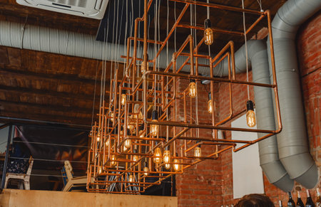 Modern loft lamp made of copper pipes in cafeの写真素材