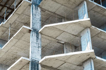 Construction of concrete apartment building. Gray frame of the building, structure