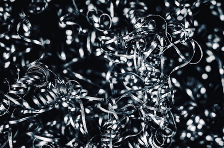 Iron metal shavings, curls, gray metal background. Macro shooting of metal processing, turning business.の写真素材