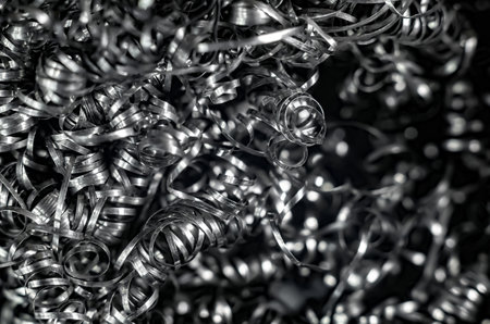 Iron metal shavings, curls, gray metal background. Macro shooting of metal processing, turning...